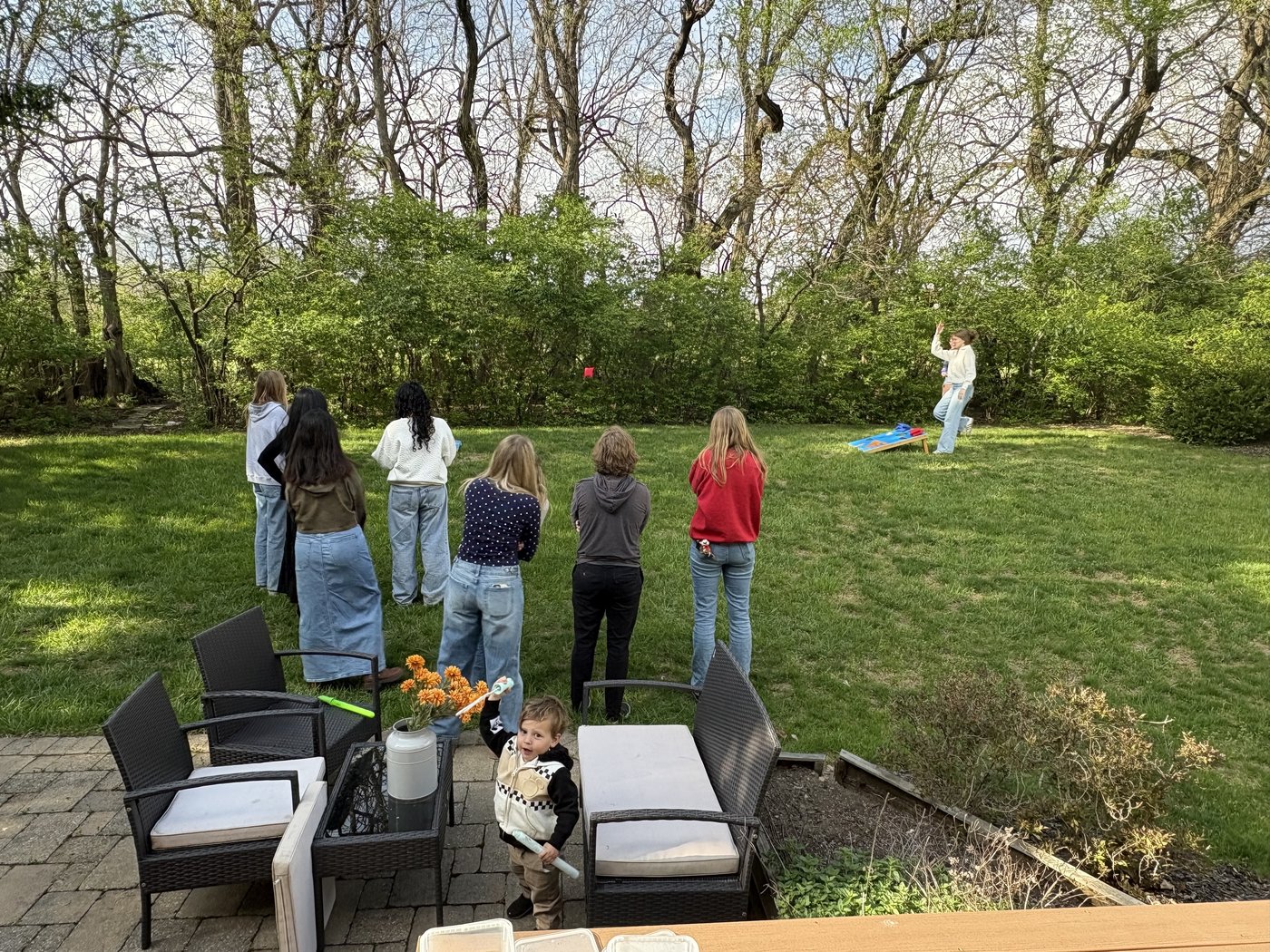 Lab members playing cornhole and Codenames.